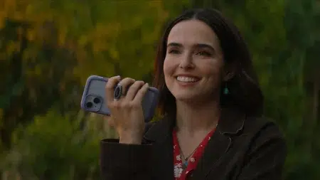 Qué ver en Netflix: 6 películas nuevas Zoey Deutch con un celular en la mano